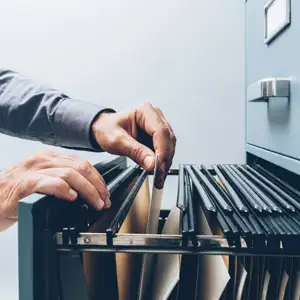 Searching Legal Files: Office Worker Filing Documents