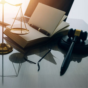Scales of justice, gavel, and law books representing civil law.