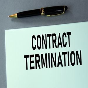 A legal document with "Contract Termination" text and a black fountain pen.