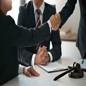 Lawyer consultant shaking hand with client sign contract agreement document. in law firm. Business meeting Handshake